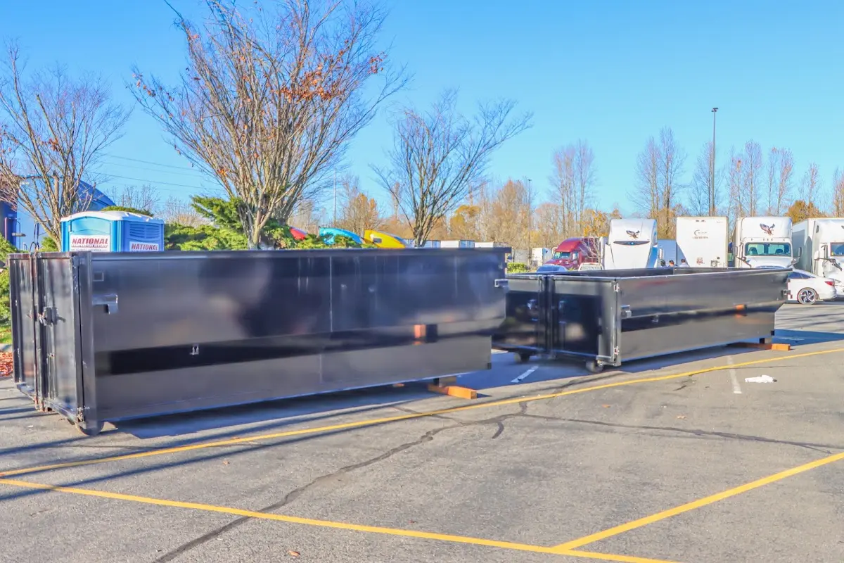 Professional dumpster rental service with roll-off container on residential driveway in Spout Springs